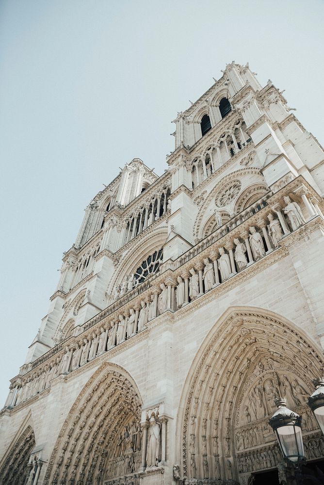 The gothic architecture and facade of Notre Dame Cathedral in Paris, France.. Original public domain image from Wikimedia…