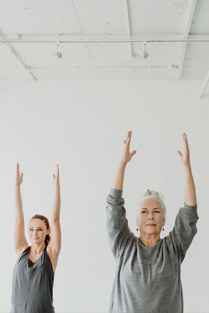Women practicing Urdhva Hastasana pose