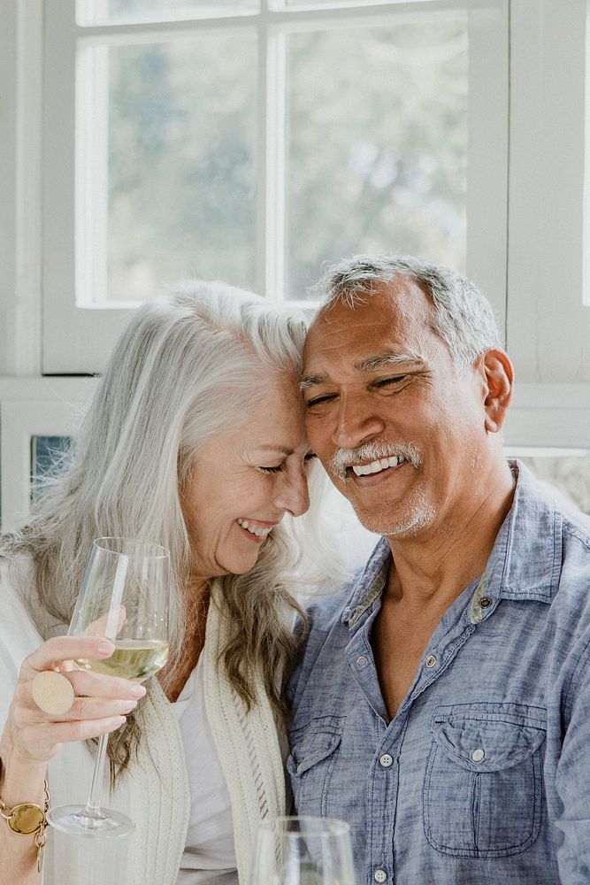Elderly couple having a white wine