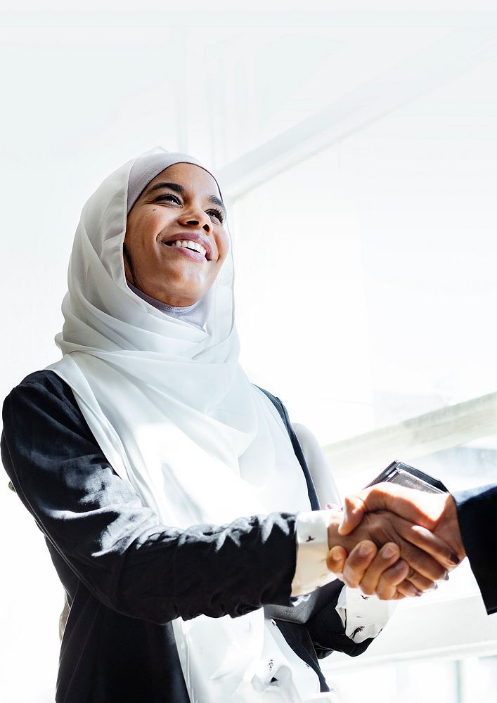 Muslim businesswoman shaking hands for a business agreement