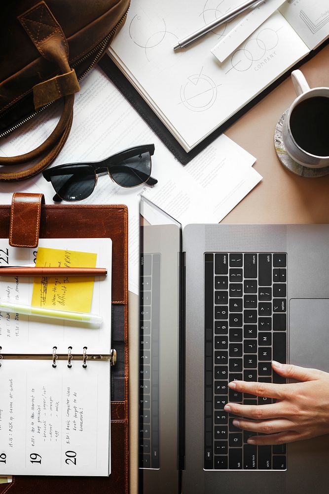 Woman using  a laptop on a messy desk