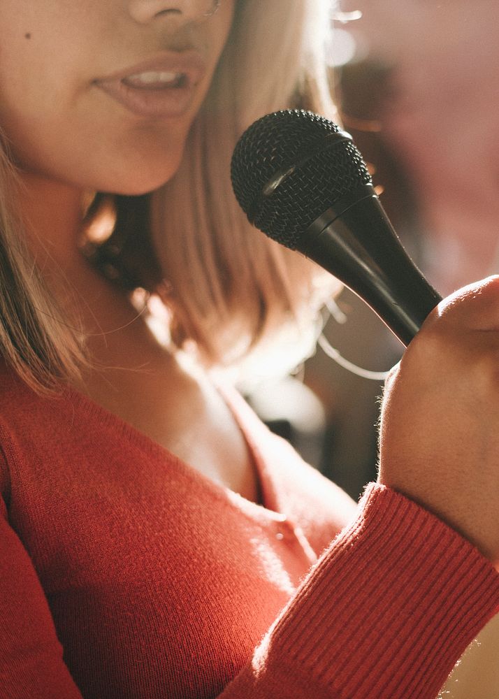 Closeup of a woman speaking on a microphone