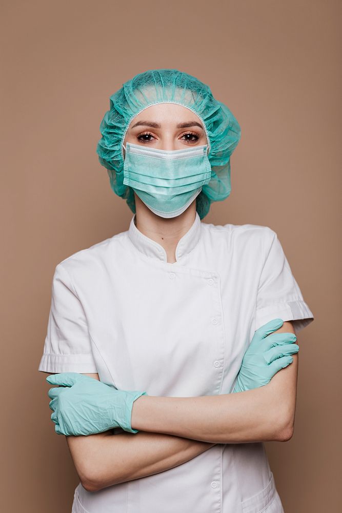 Confident microbiologist wearing gloves mask and surgical cap