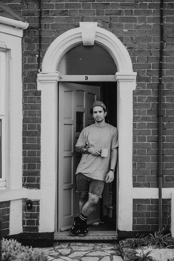 Man having his morning coffee by the doorway of his house during the covid-19 pandemic in Britain. APRIL 5, 2020 - BRISTOL…