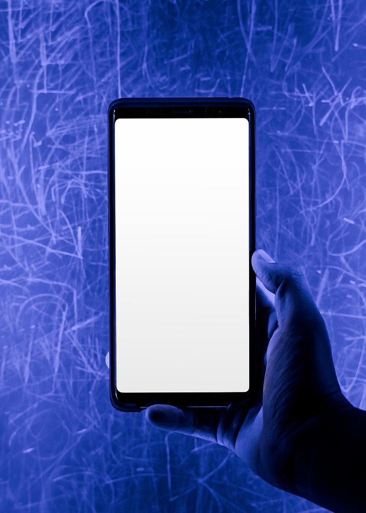 Smartphone screen by a blue grunge wall