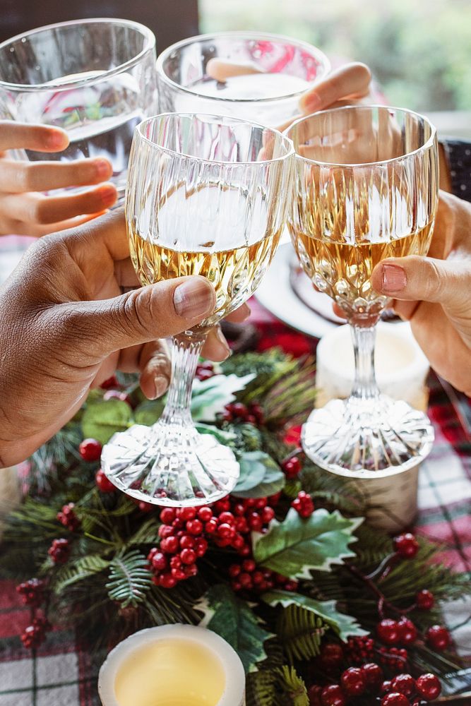 Family clinking with glasses at Christmas dinner table