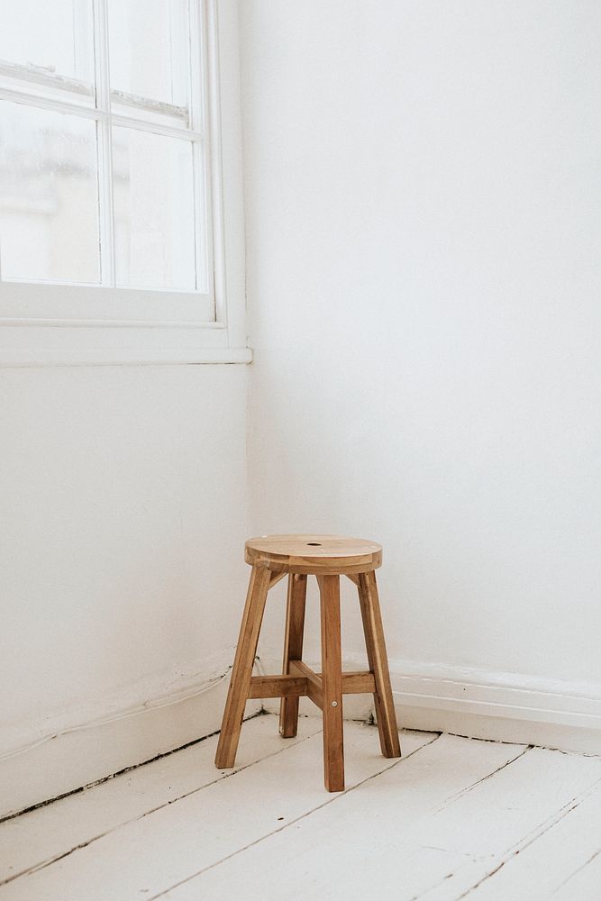 Wooden stool in the corner of a room