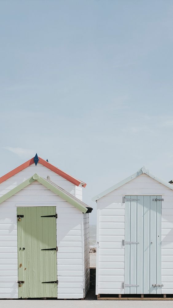 Phone wallpaper background, pastel beach huts by the beach