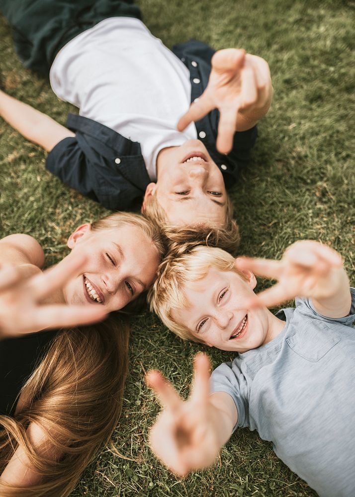 Kids lying on a grass, family photo