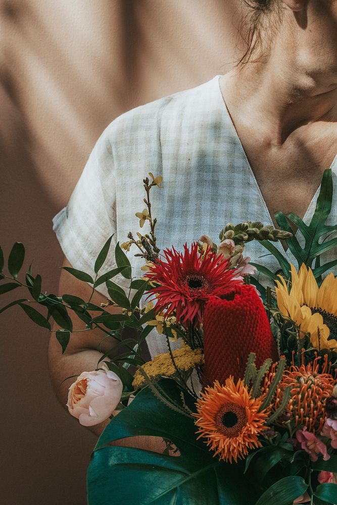 Woman with a beautiful tropical bouquet