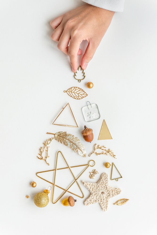 Woman making a Christmas tree with gold ornaments aerial view