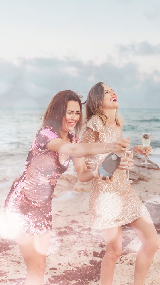 Women with champagne at the beach with bokeh effect mobile phone wallpaper