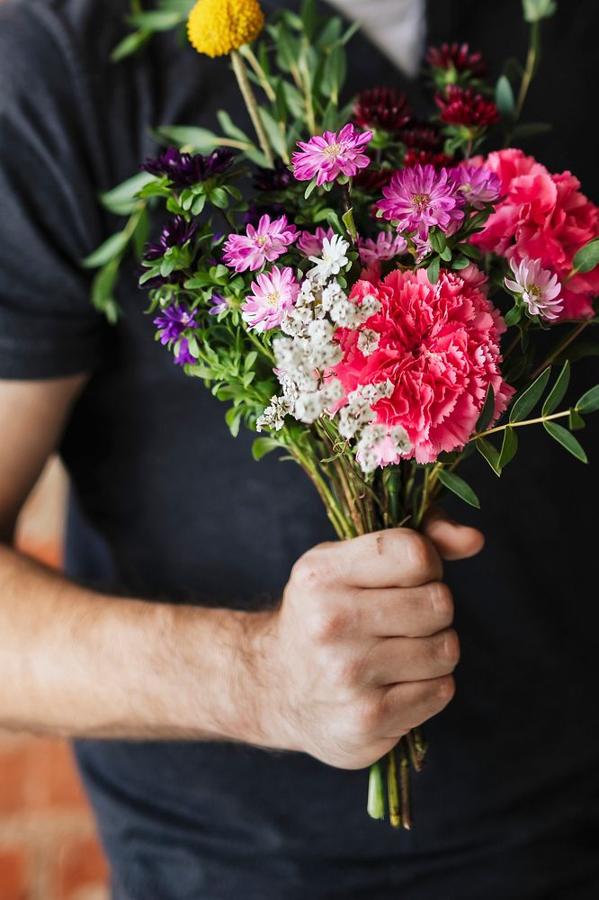 Man holding a bouquet of flowers