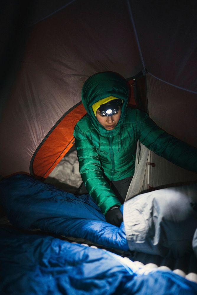 Preparing a sleeping bag in a tent for the cold night
