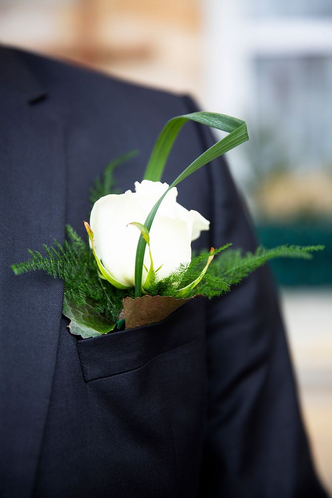 Groom wearing a boutonniere on his wedding day