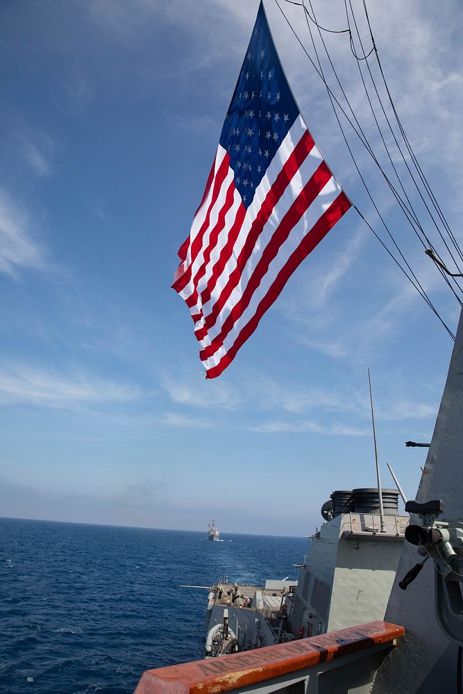 MEDITERRANEAN SEA (April 15, 2021) The Arleigh Burke-class guided-missile destroyer USS Donald Cook (DDG 75) sails behind…