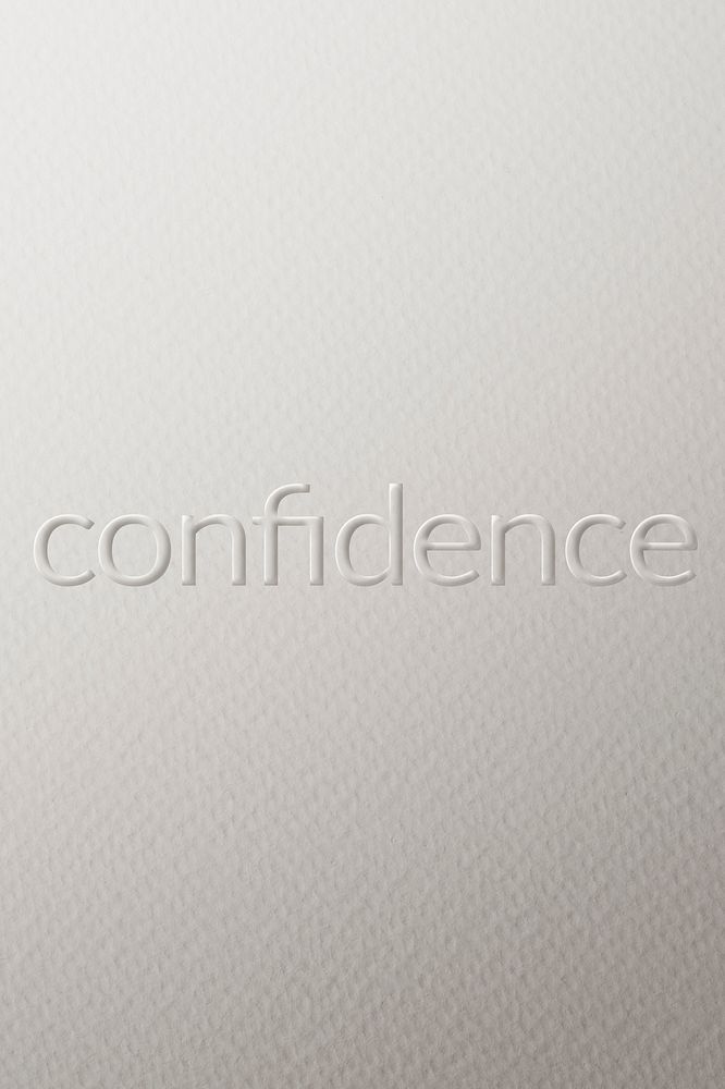 Confidence embossed text white paper background