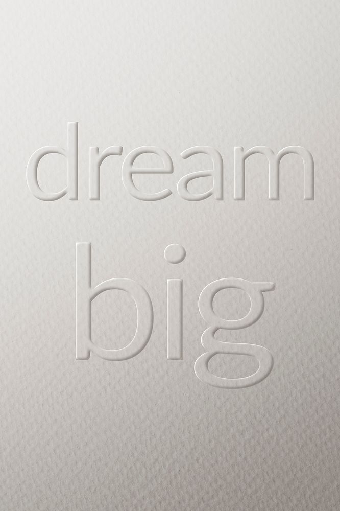 Dream big embossed font white paper background