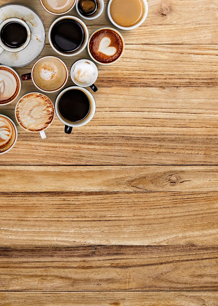 Coffee cups on a brown wooden panel  