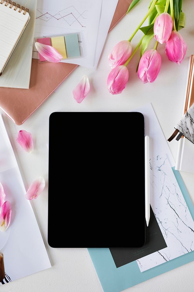 Digital tablet on a table with flowers