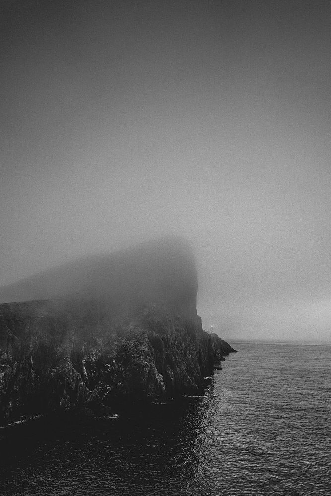Misty view of Neist Point Lighthouse on the Isle of Skye in Scotland