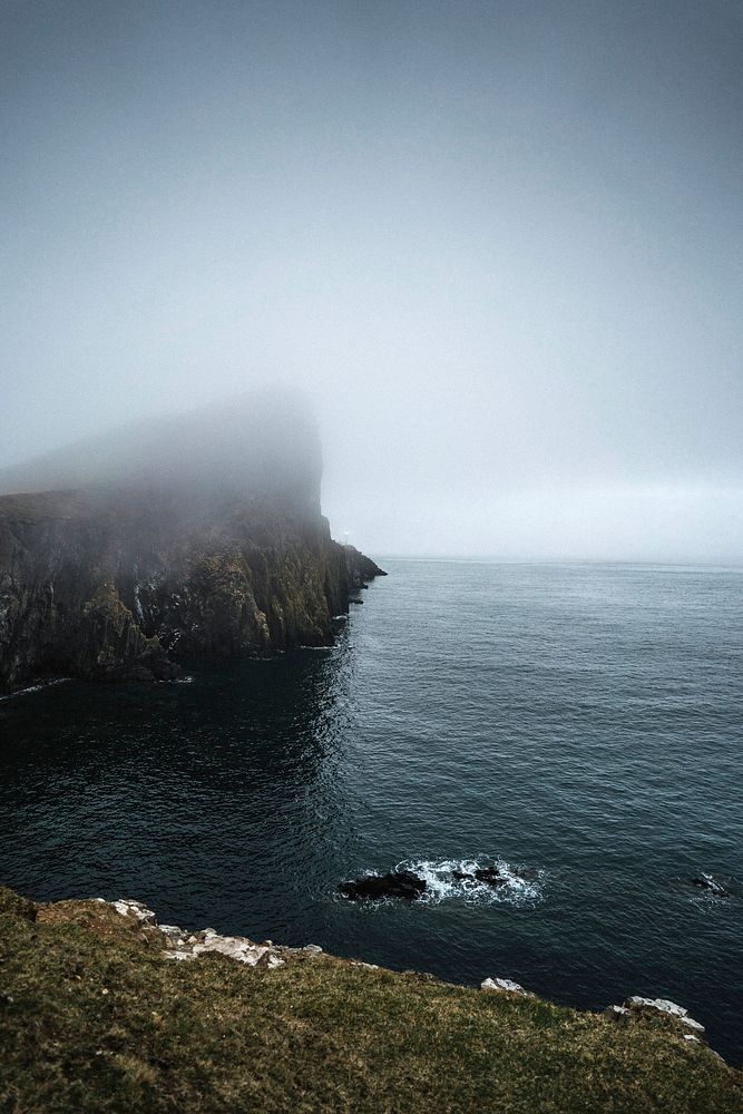 Misty view of Neist Point Lighthouse on the Isle of Skye in Scotland