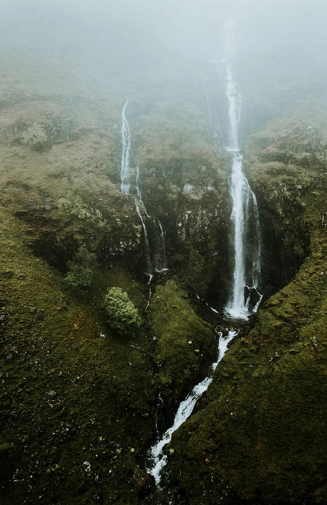 Fog covering a narrow waterfall in Scotland