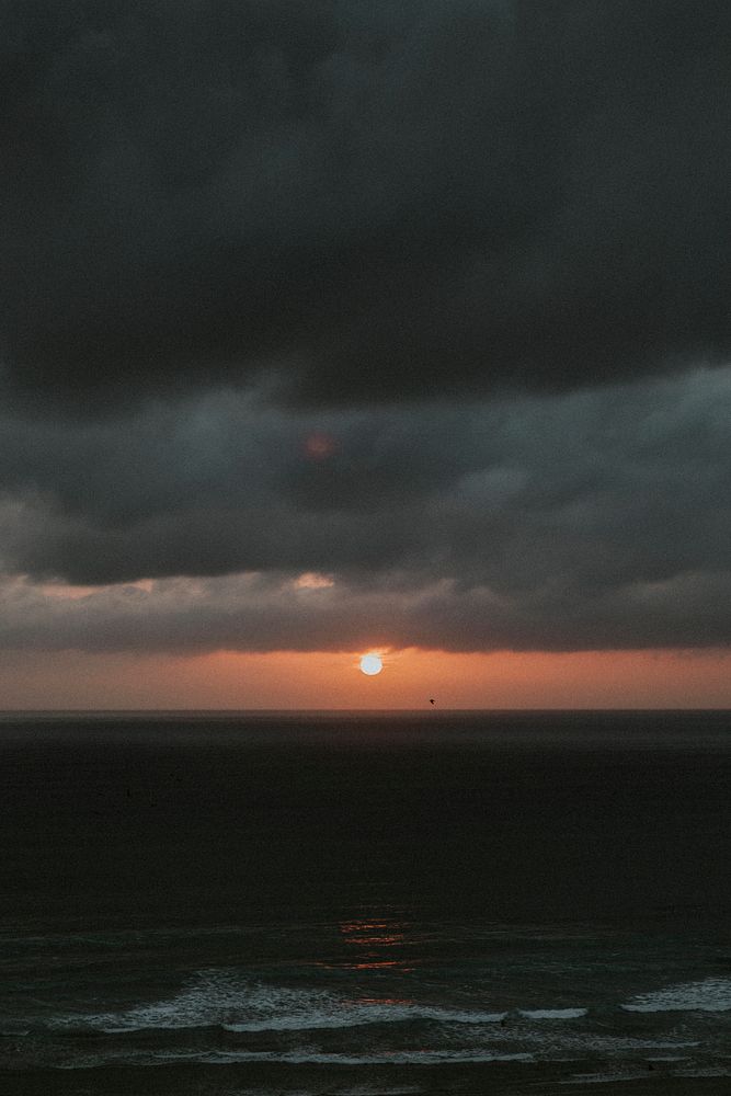 Orange sky over the gloomy beach