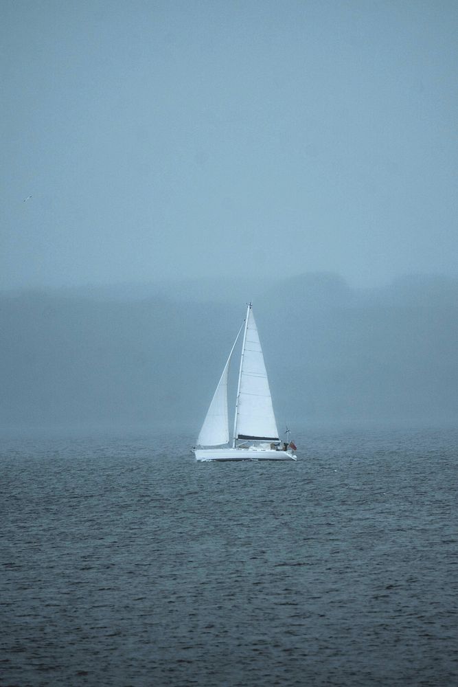 Fog taking over the sailing boat on the sea