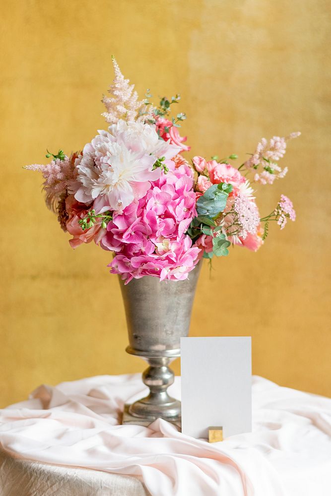 Flower vase by a card on a table