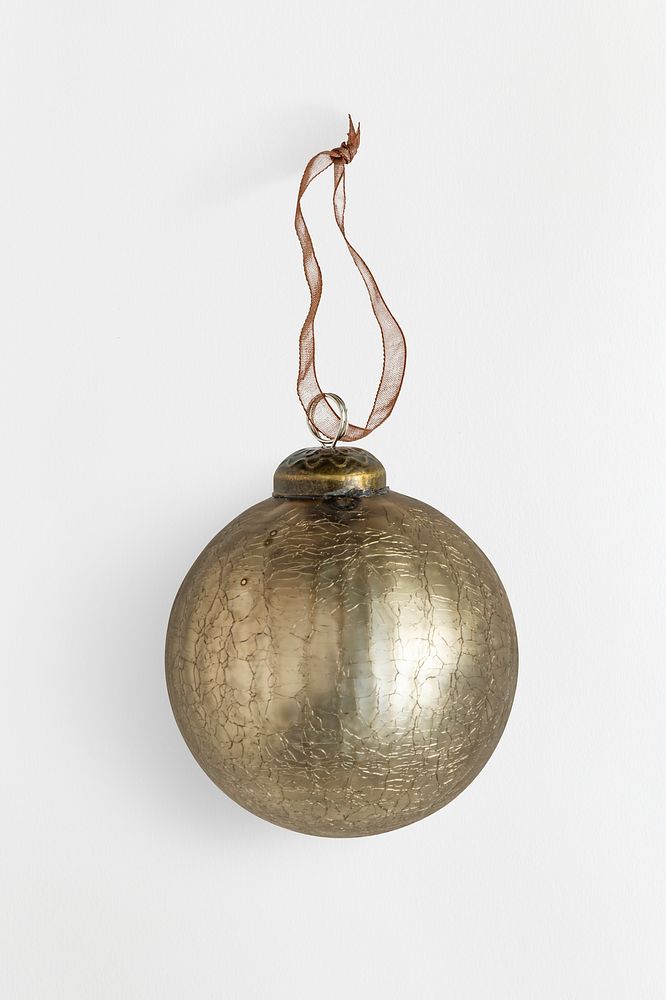 A shiny gold ball Christmas ornament isolated on gray background