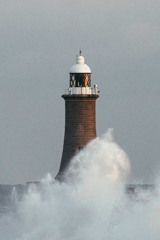 Huge wave hitting a lighthouse in Scotland
