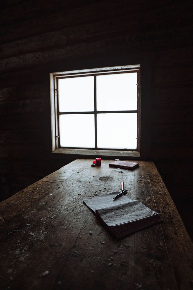Journal on a wooden table in a forest cabin