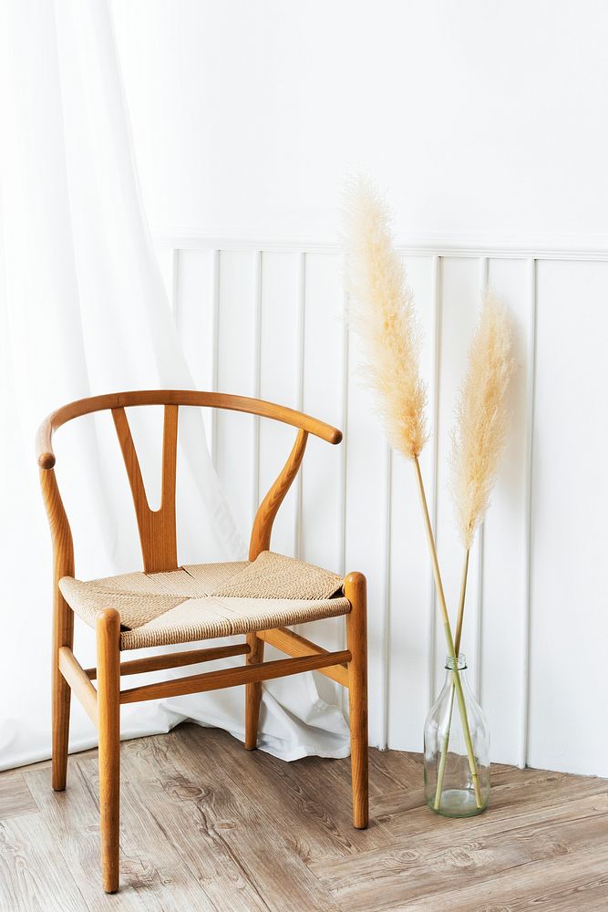 Classic wooden chair by a vase of dry pampas grass