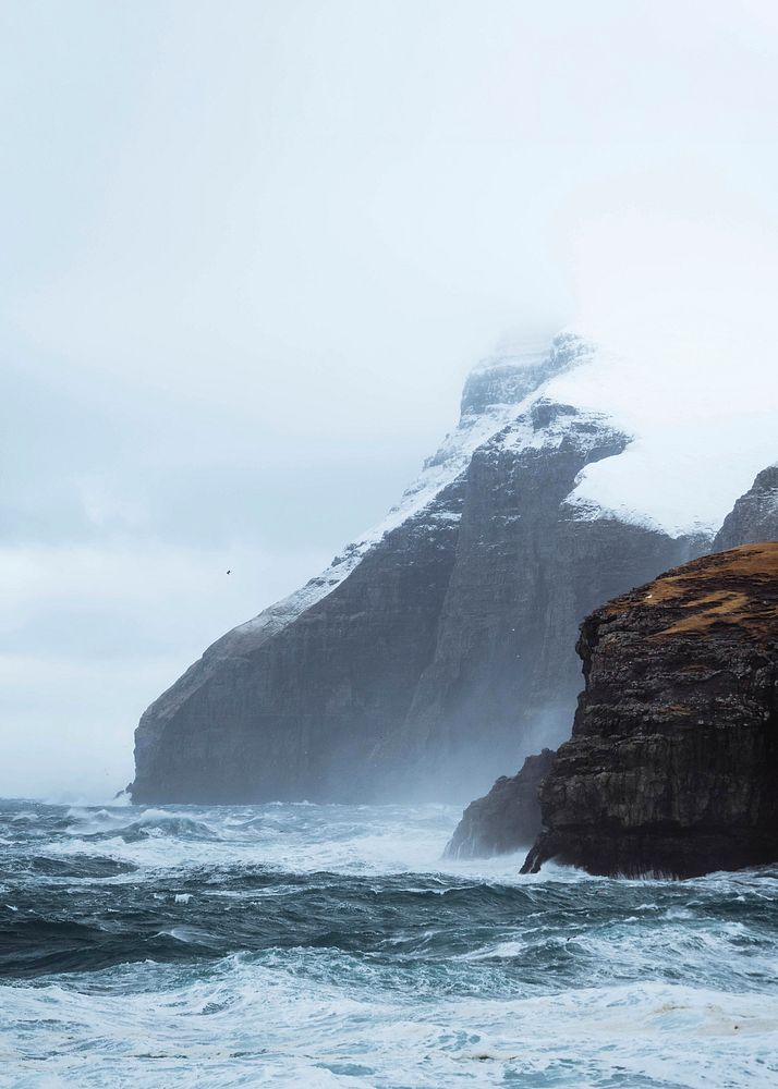 Wave hitting the cliffs of M&oslash;lin beach in Streymoy, Faroe Islands