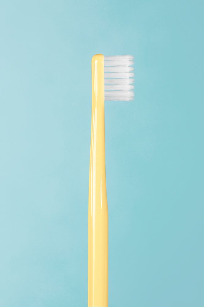 Yellow toothbrush on a blue background