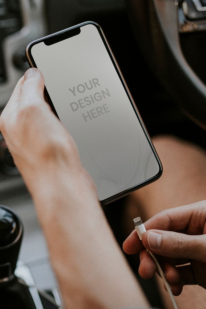 Blank smartphone screen mockup charging in a car