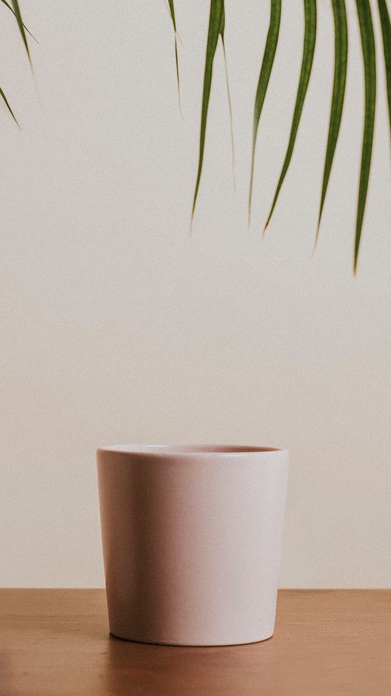 Earth tone color ceramic coffee cup on wooden table