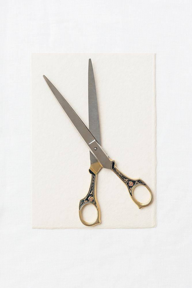 Vintage scissors on a white paper background
