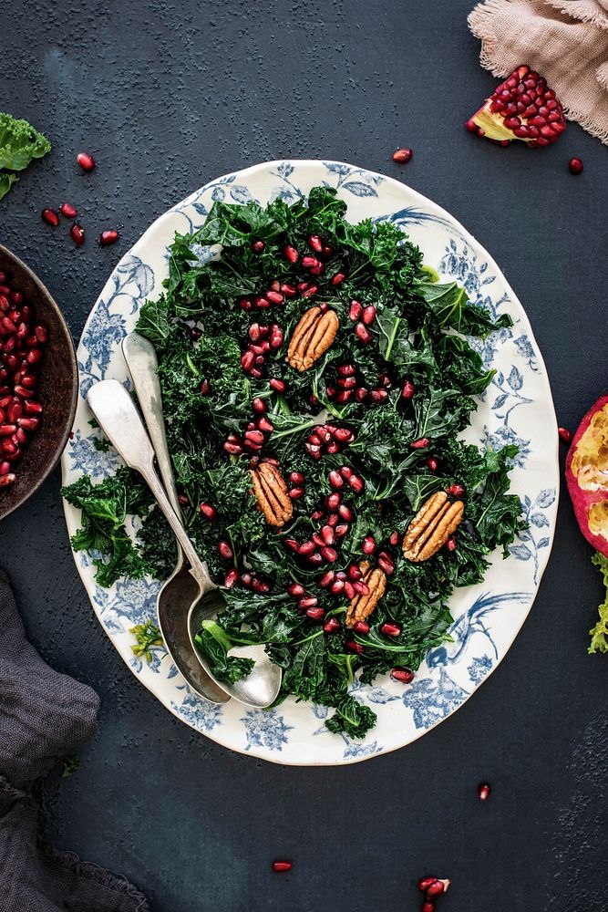 Kale salad with pomegranate and apple with pecans food photography