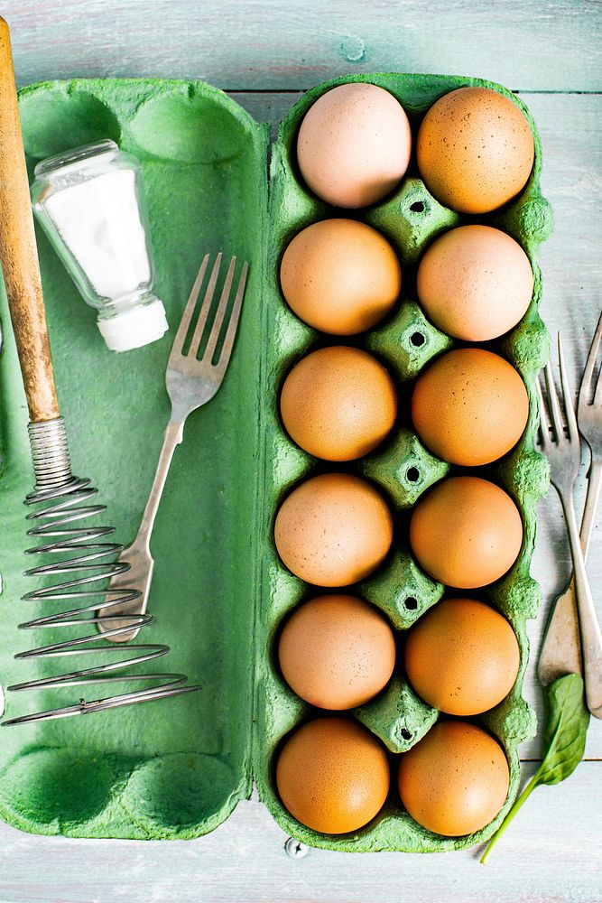 Fresh raw eggs in a carton box food photography