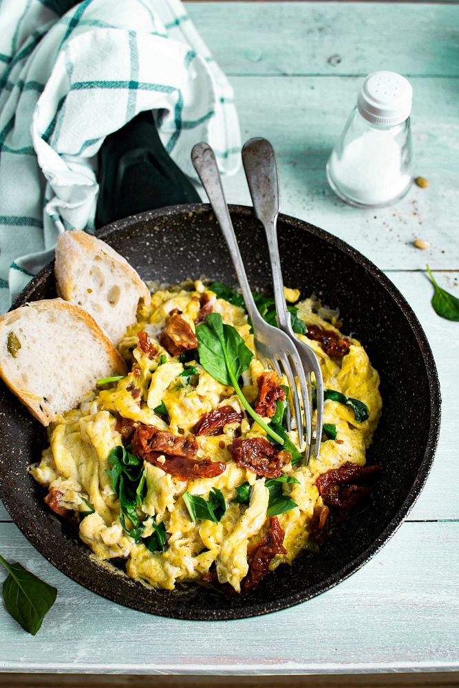 Scrambled eggs with spinach and sun dried tomato food photography