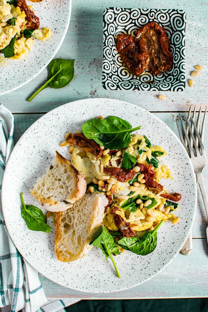 Scrambled eggs with spinach and sun dried tomato food photography