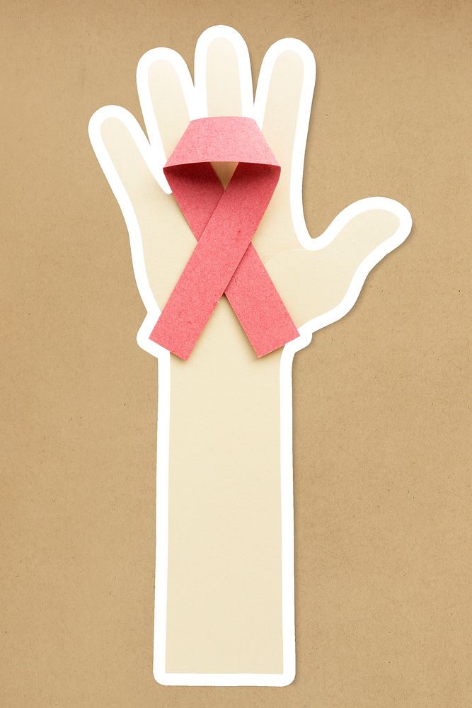 Hand holding a pink ribbon paper craft sticker