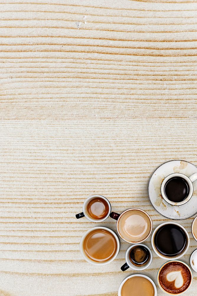 Coffee mugs on a light beige wooden textured background