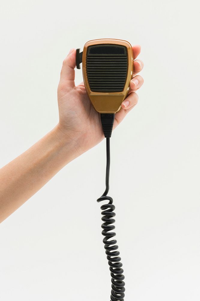 Man using a microphone walkie talkie for \ broadcasting 