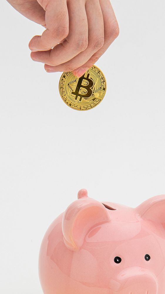 Woman inserting a bitcoin into a pink piggy bank
