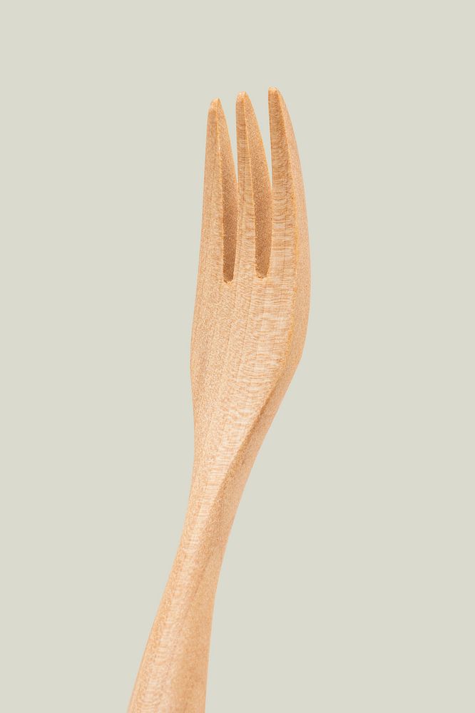 Natural wooden fork on off white background