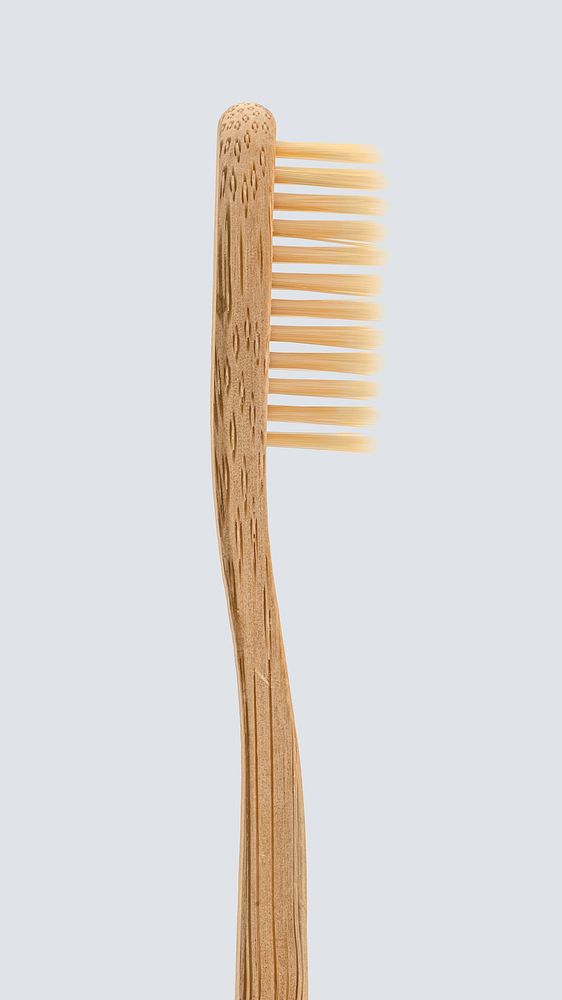 Natural bamboo toothbrush on off white background