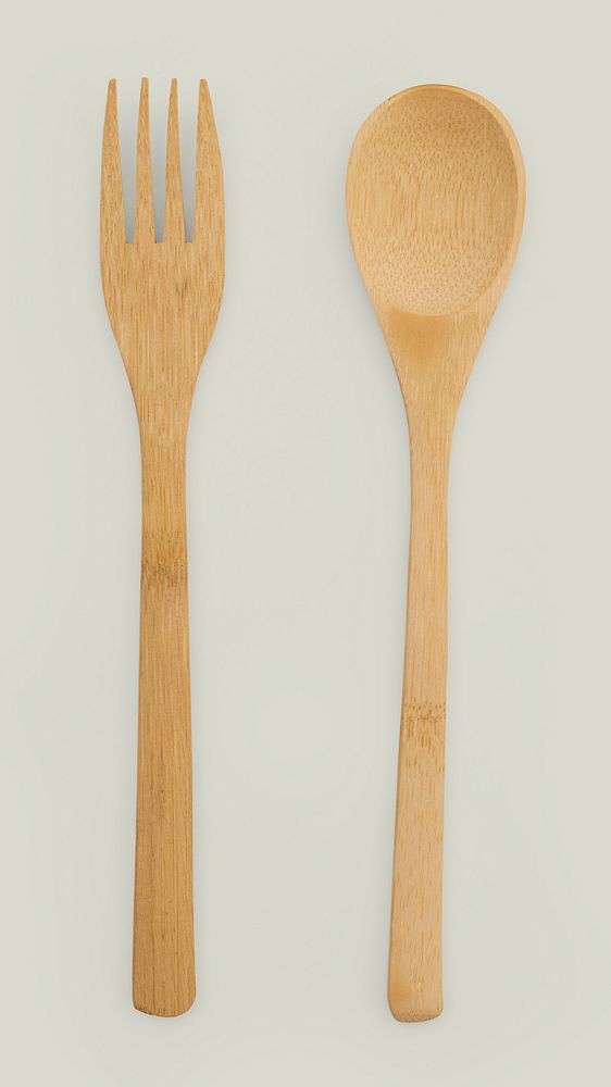Wooden spoon and fork on off white background